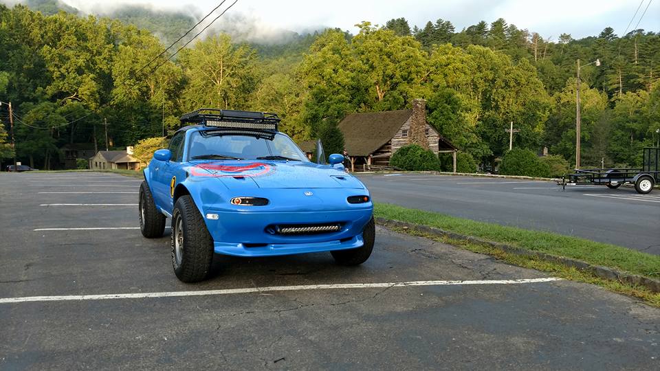 Blue mazda from front angle in a parking lot