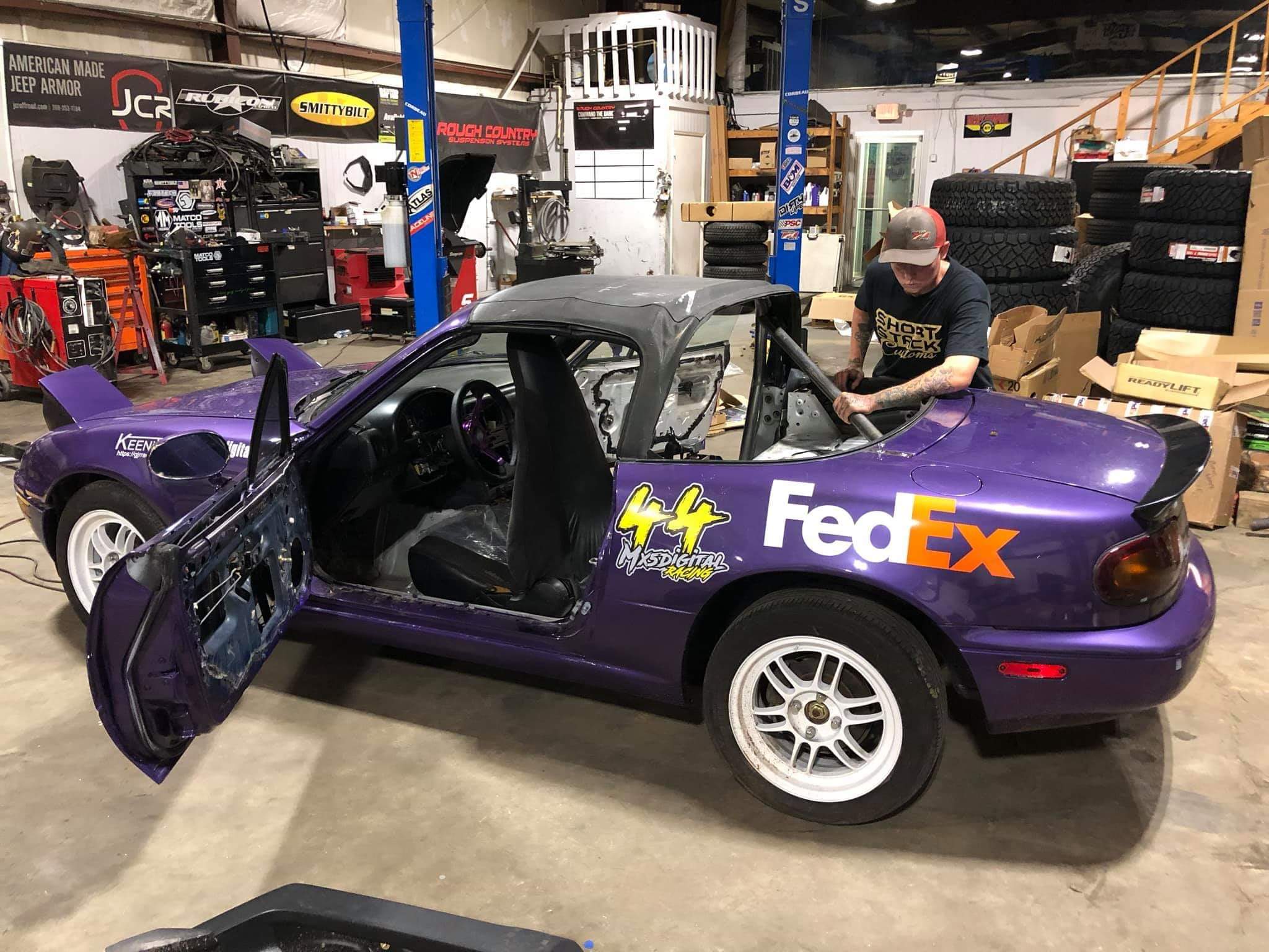 Purple mazda with FedEx logo